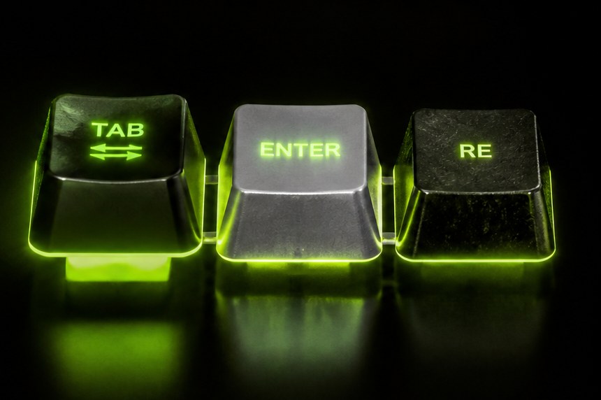 Three keycaps lit side by side — a matte black TAB, a titanium ENTER, and a black RE